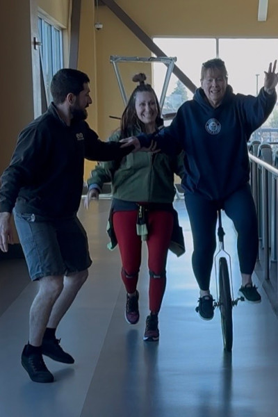 Linda riding with the help of her grown kids