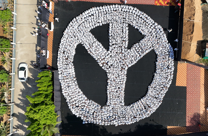 People wearing white t-shirts to make a peace sign