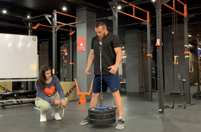 A man lifting weights with his beard