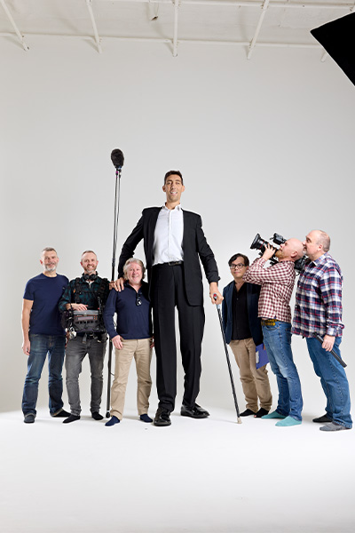 Sultan standing with documentary crew