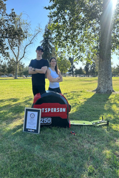 Ali next to the tape measure