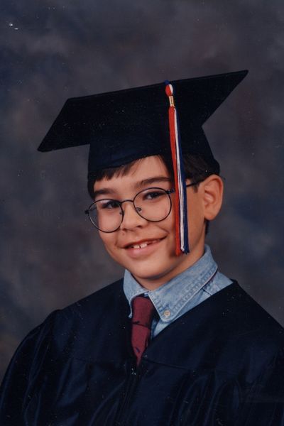 Youngest graduate in his graduation cap