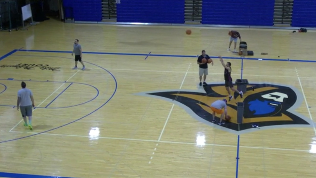 Birds eye view of the basketball court as Ryan makes a half court shot