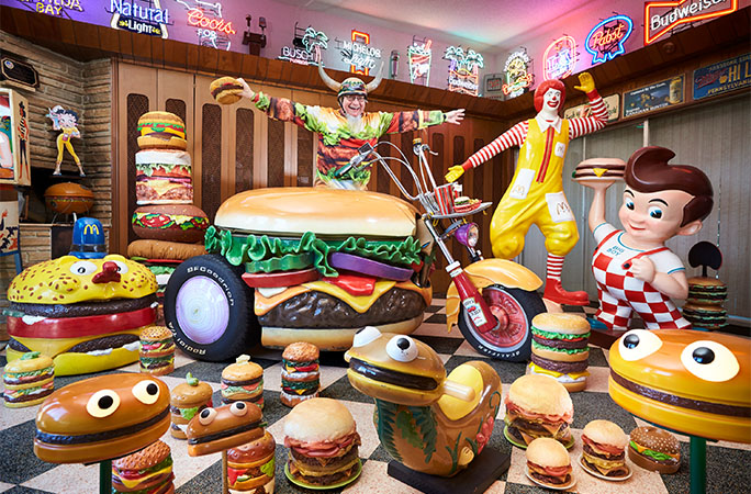 a man surrounded by his hamburger collection