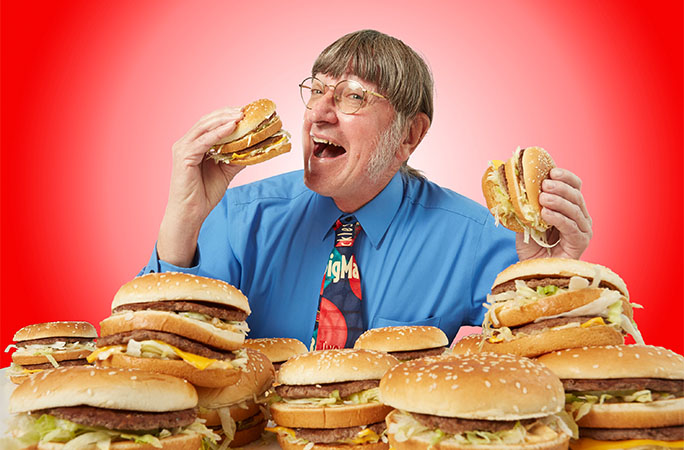 a man surrounded by Big Macs
