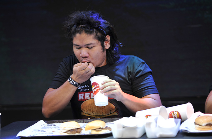 a man eating hamburgers