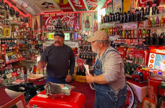 Bardo showing off the room to another man in the club