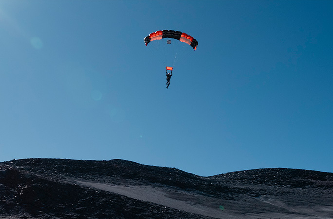 Super Toom coming down to land with his parachute open