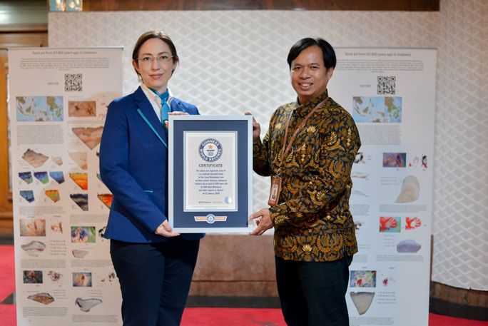 Oldest cave art Dr. Adhi Agus Oktaviana receiving the certificate