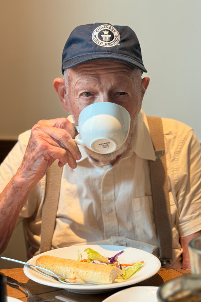 Robert at a celebratory meal with a GWR hat