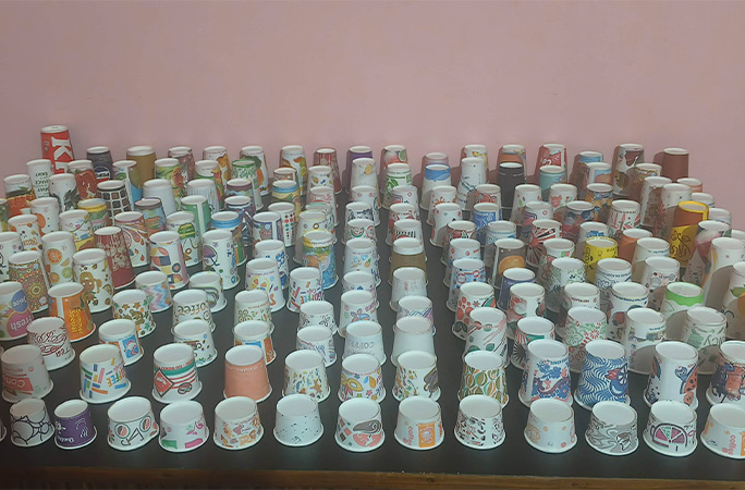 hundreds of paper cups on a table