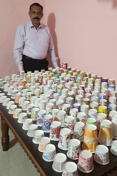 Sunil with his paper cup collection