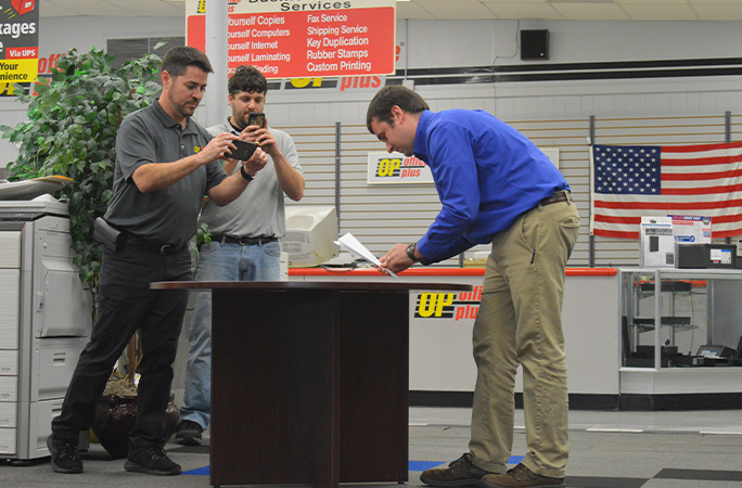 Charles Haynsworth IV folding a paper plane