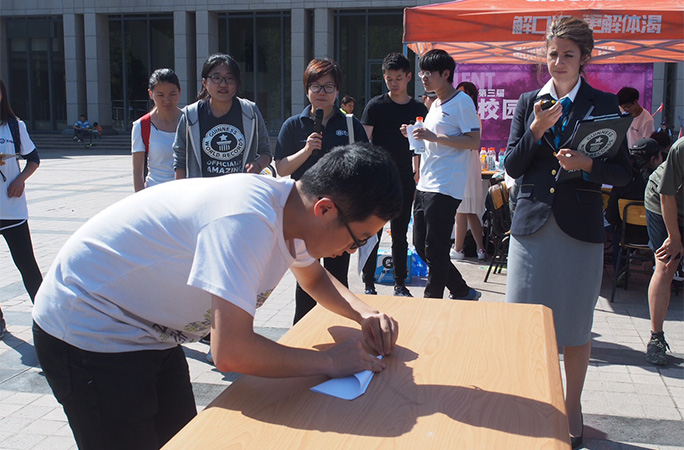 Lu Yu folding a paper plane