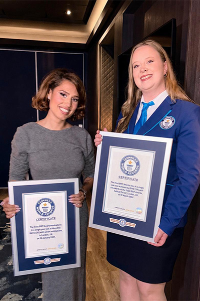 Raye holding certificates with GWR's Emma Salt