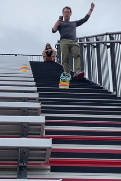 Joe filming as the slinky descends down the stairs