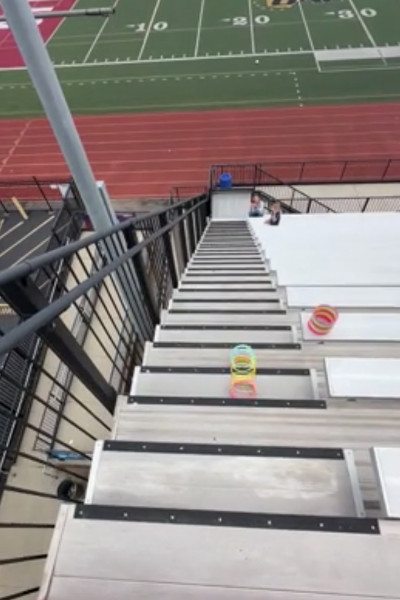 The slinky going down the stairs towards the field