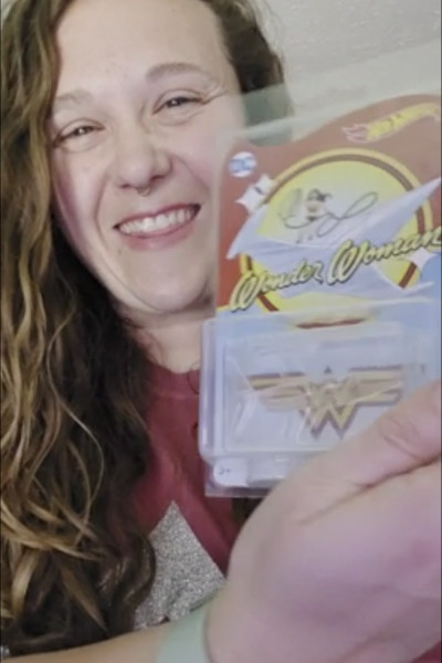 Aleshia holding a Wonder Woman invisible jet