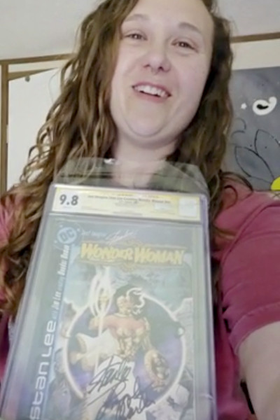 Aleshia holding her signed WW comic
