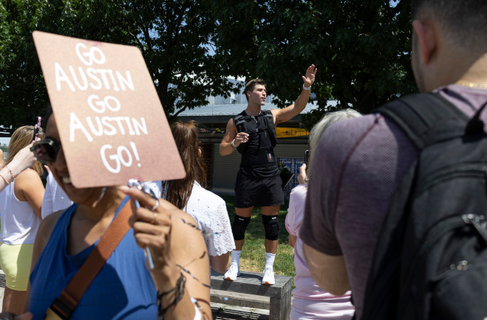 Austin next to a sign cheering him on