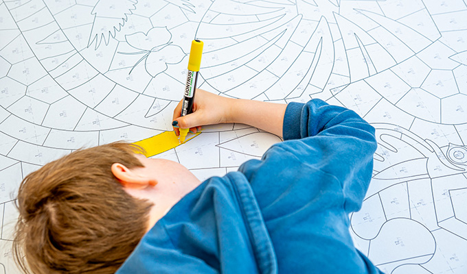 Child coloring the artwork
