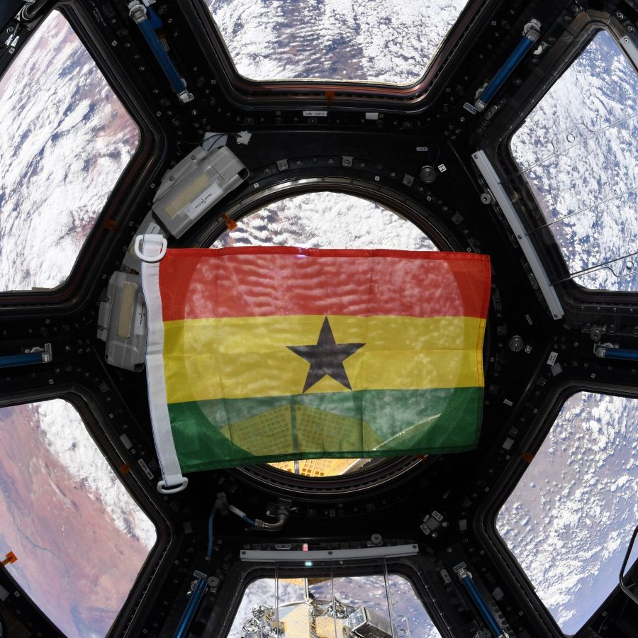 A small Ghanian flag floating in zero-g on the International Space Station
