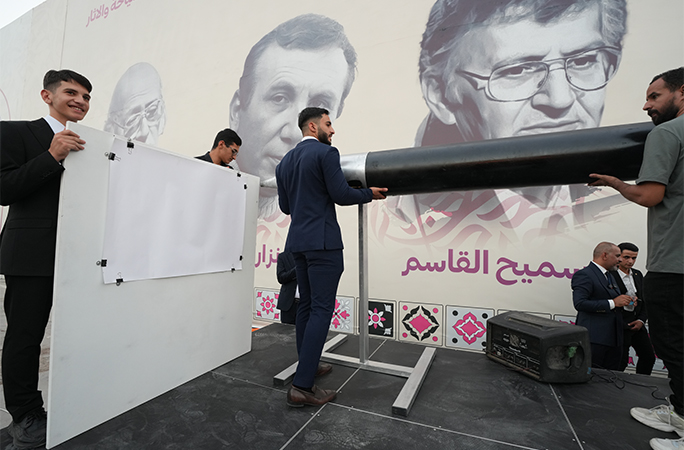 a group of men lifting the ball point pen into place