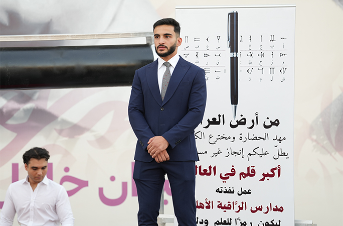 Yahya stood next to the largest ball point pen