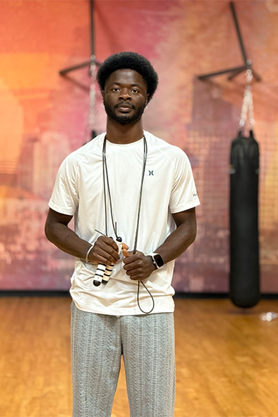 Dflex posing with a skipping rope dangling round his neck