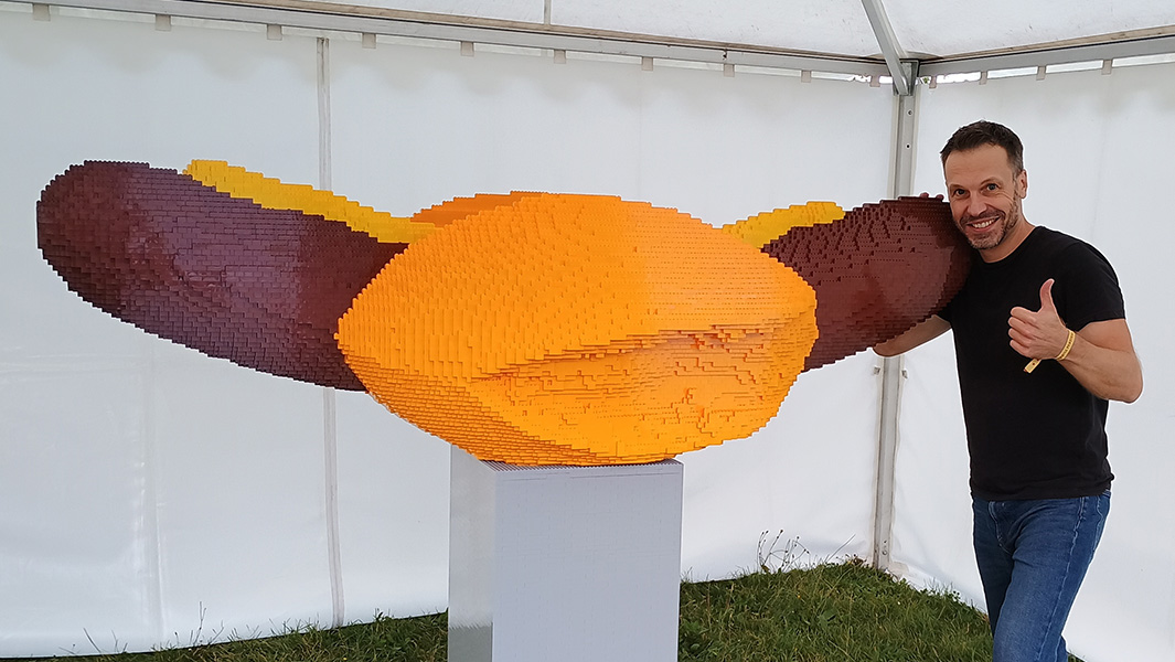 Tommy stood next to his giant LEGO sausage