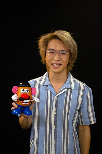 Lim Kai Yi holding Mr Potato Head