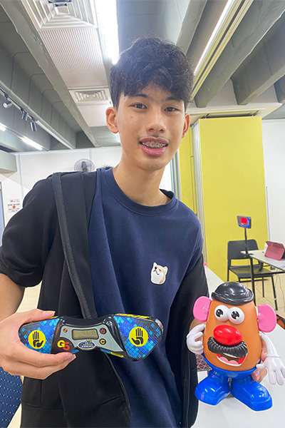 Calen holding Mr. Potato Head and a timer