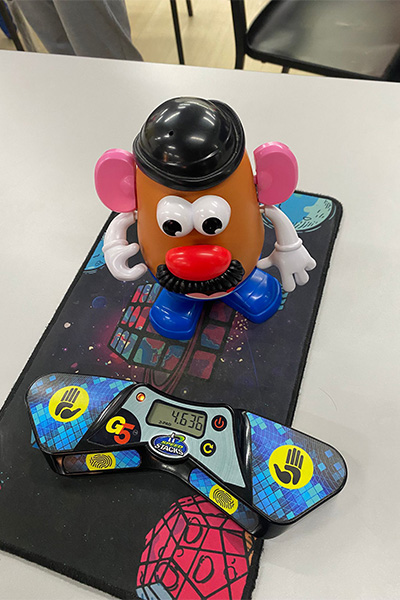assembled Mr. Potato Head toy next to a timer