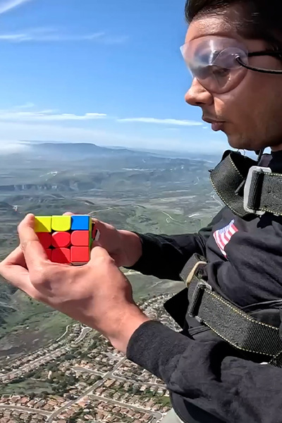 Ishaan working on a cube while skydiving
