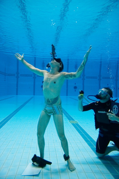 Chayne mid attempt next to the Adjudicator in a dive suit