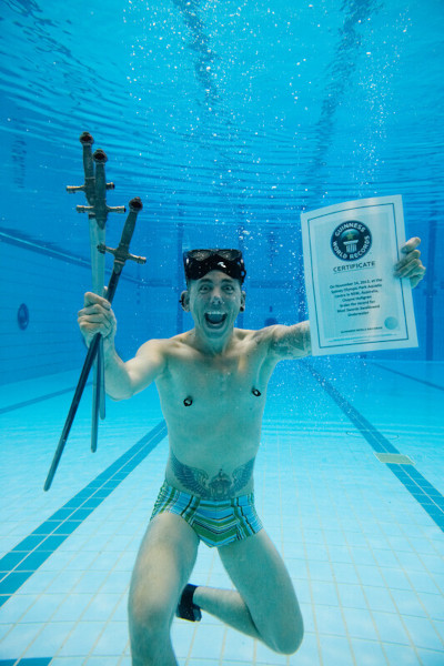 Chayne holding his GWR certificate underwater