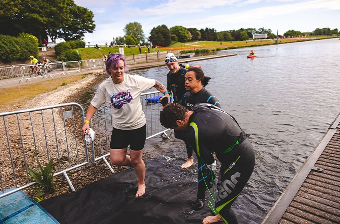 Michael being helped out of the water after his swim