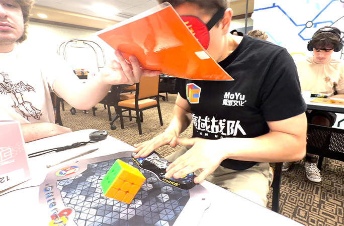 Tommy dropping the cube and stopping the timer