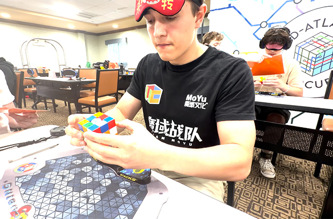 Tommy studying the cube