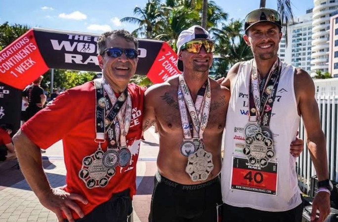 Christian posing with 2 men after the race