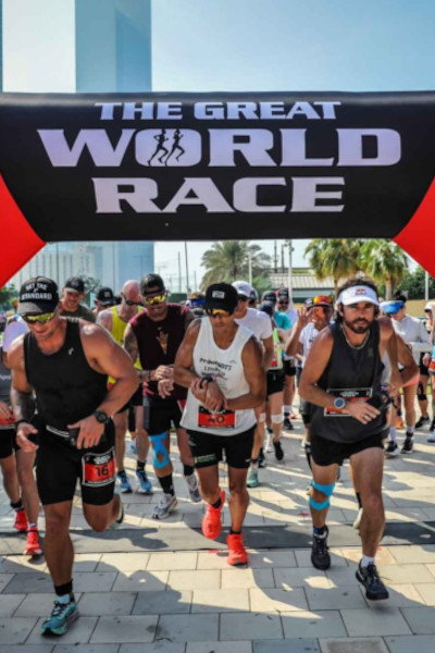 Christian running through the starting line with competitors
