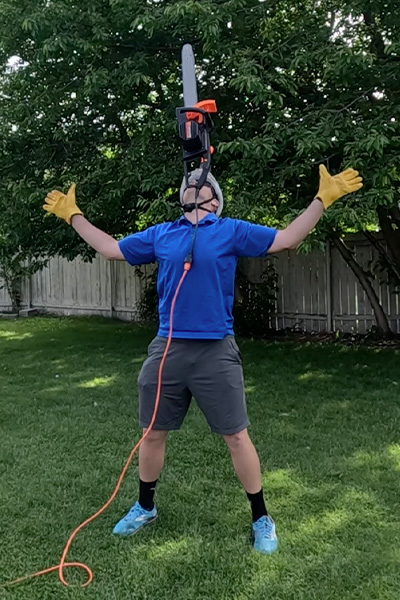 David balancing a chainsaw on his chin