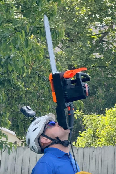 David balancing a chainsaw on his chin