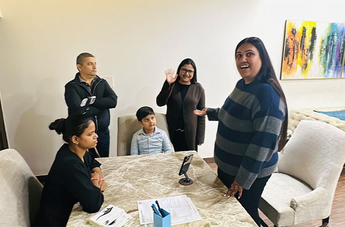 Avyukt surrounded by his family members while sitting at a table