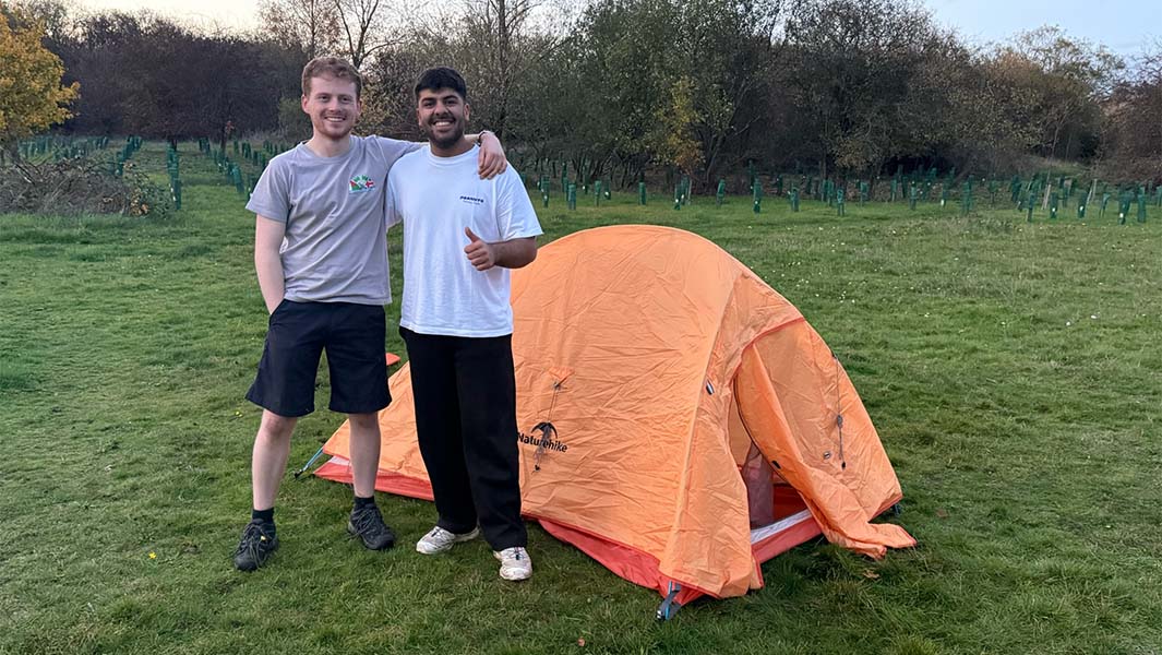 Param and Adam standing by their finished tent
