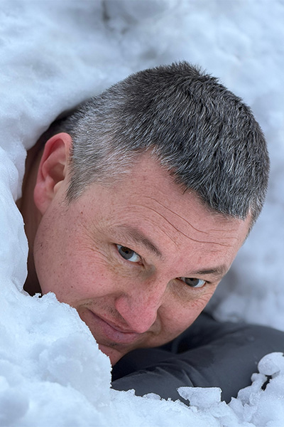 Damian's head sticking out of the snow