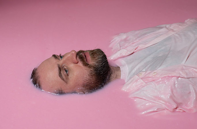Pictish Trail lying in a bath of pink slime
