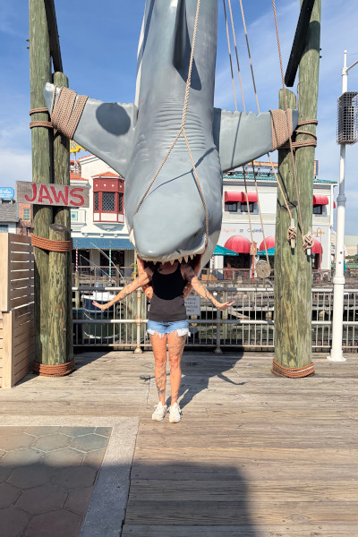 Emily being eaten by a fake shark on the boardwalk