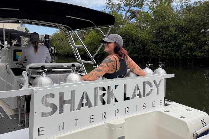 Emily sitting on the Shark Lady Enterprises boat