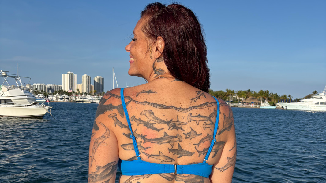 Split image of Emily's back tattoos and Emily diving with a shark
